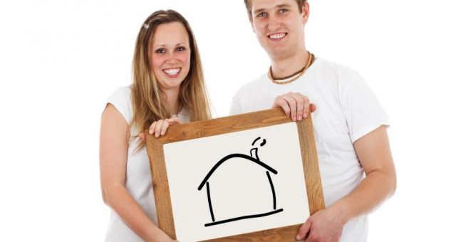 couple holding a house drawing