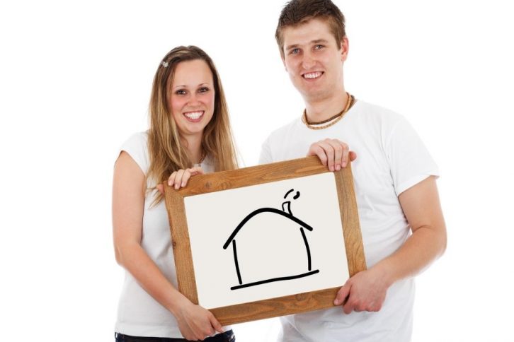 couple holding a house drawing