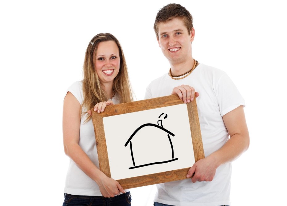 couple holding a house drawing